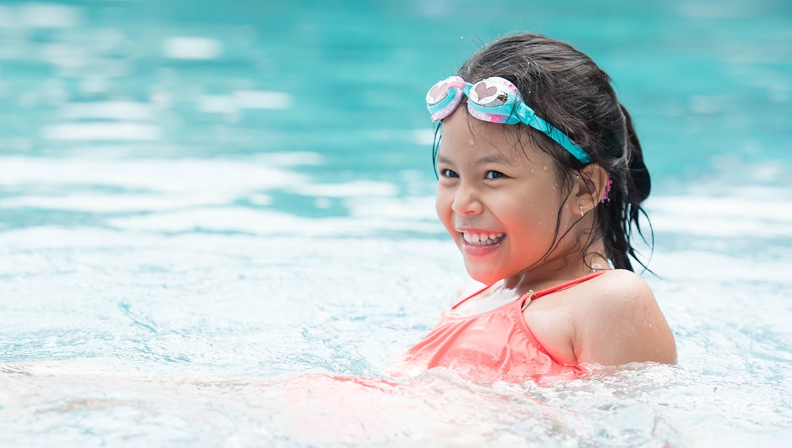 Girl wearing goggles in pool