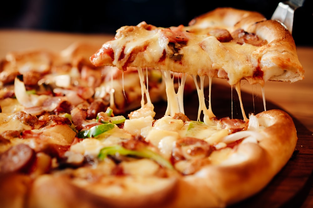 Slice,of,hot,pizza,large,cheese,lunch,or,dinner,crust
