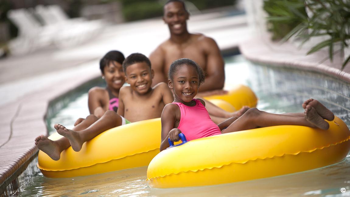 Girl with family enjoying the Crown Reef lazy river