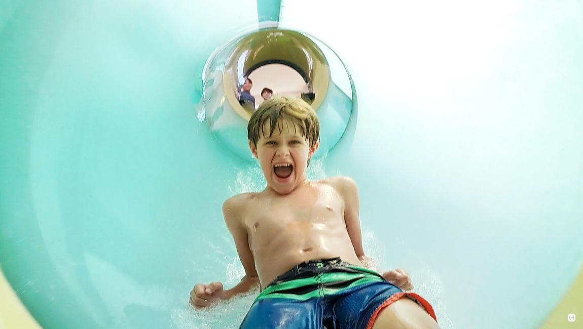 Boy having fun sliding down the slide