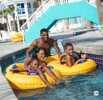 Family floating down the lazy river ride at Crown Reef