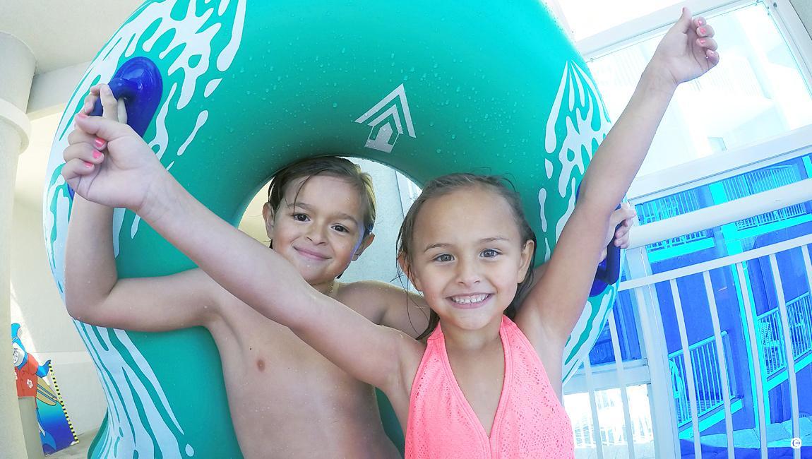 Brother and sister getting ready to go down the waterslide at Crown Reef waterpark