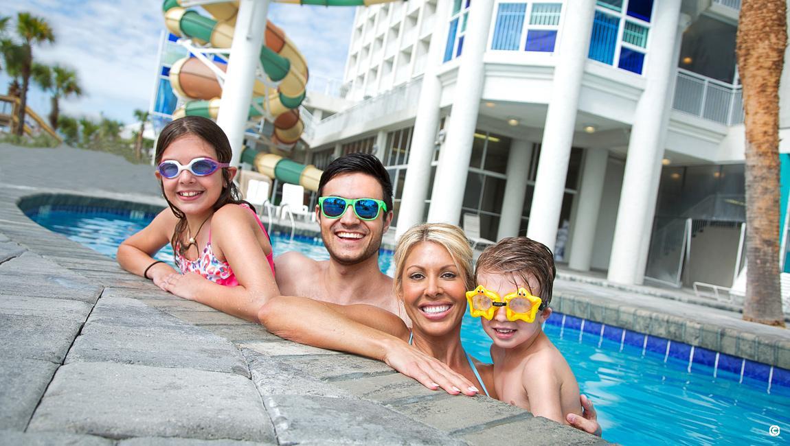 Family by the pool at the Myrtle Beach hotel